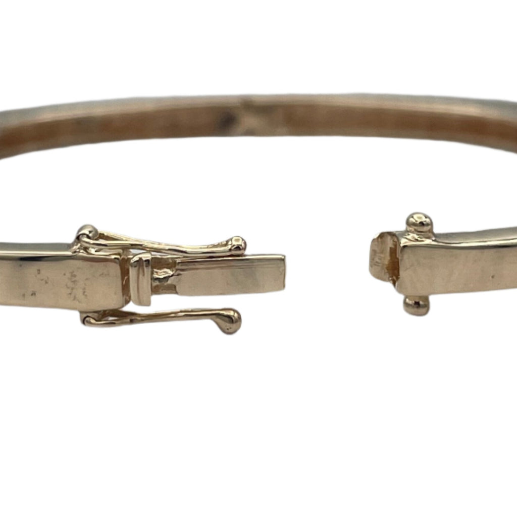 Lovely 14k hollow yellow gold and diamonds bangle bracelet. This bangle attaches with a slide clasp.