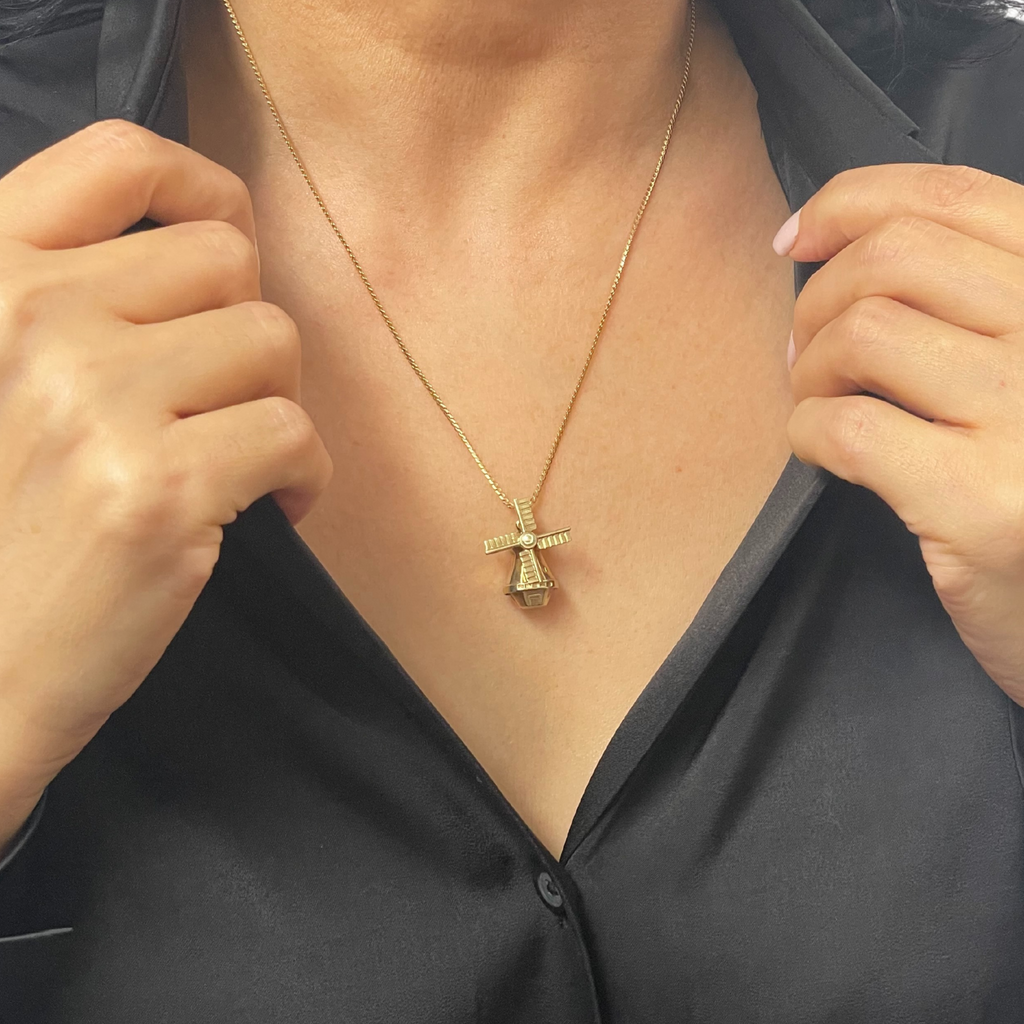 Lovely vintage 14k yellow gold rotary windmill charm with moving sails.